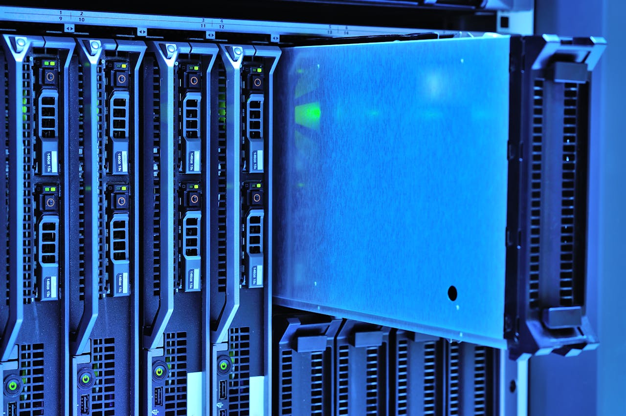 gallery-1 Detailed view of server racks with glowing lights in a data center environment.